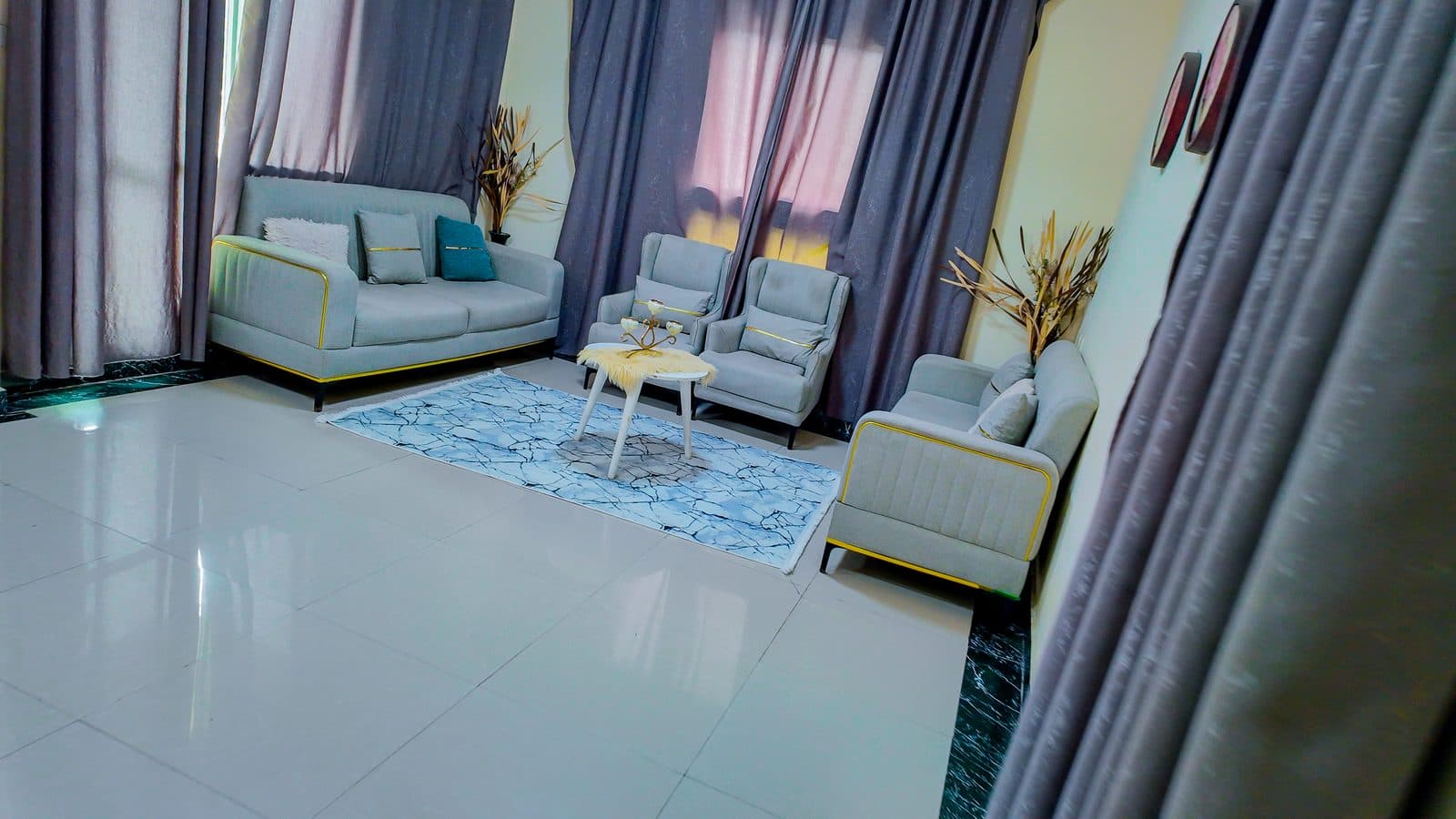 Seating area with sofas and armchairs gathered around a small round table