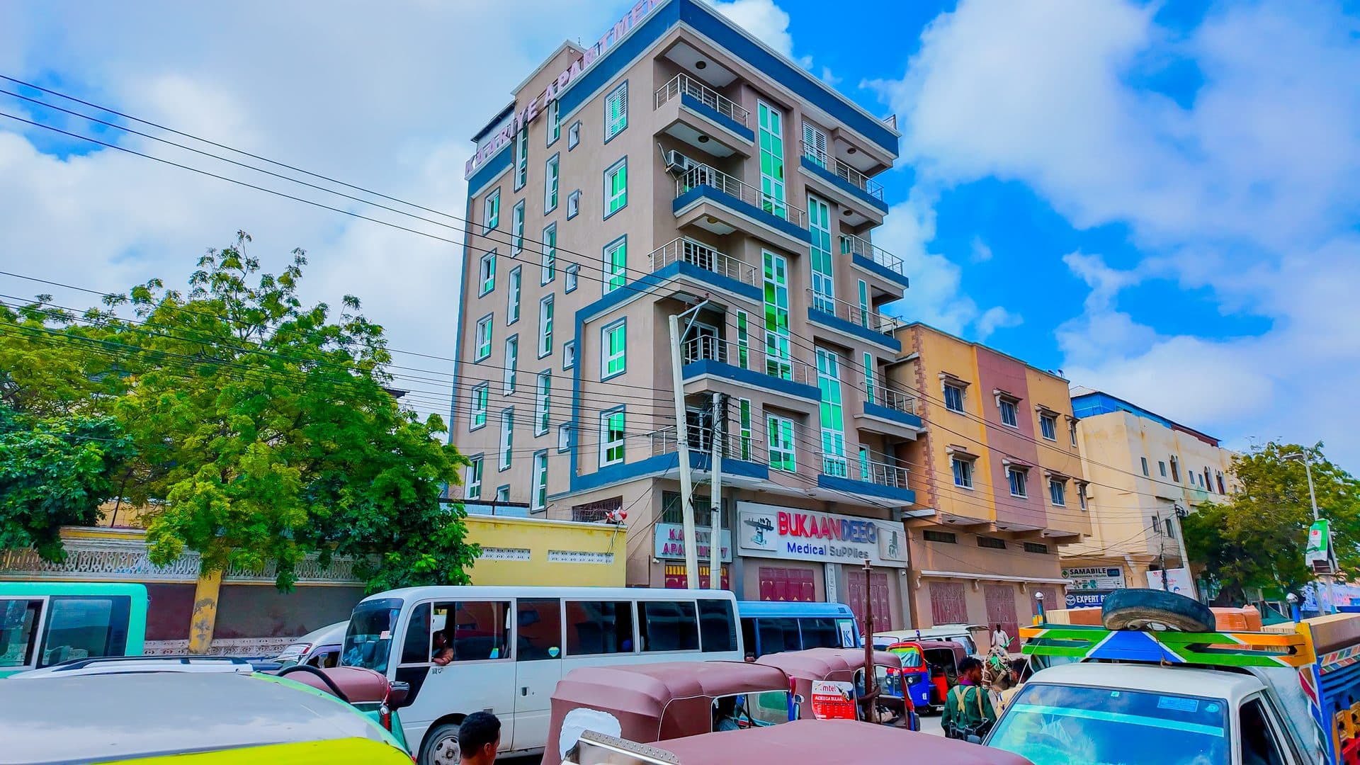 The Kaariye Apartments building in Mogadishu, its balconies rising above the shops on the street below