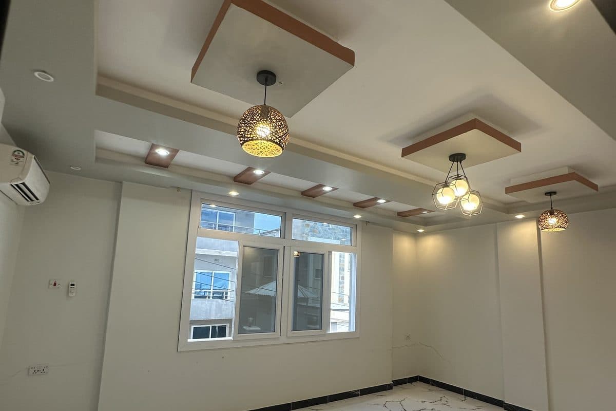 Unfurnished living room with a coffered feature ceiling, woven pendant lights and spotlights, a wall-mounted air conditioner and a wide window